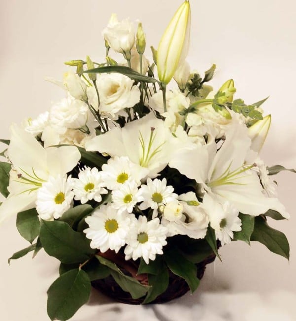 Basket arrangement of white blooms: Lilys, Roses, Chrysantemums