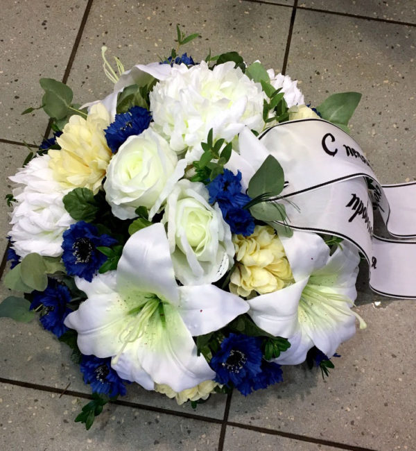 Round-shaped funeral arrangement with artificial flowers