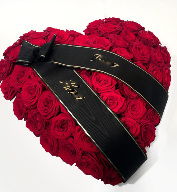 Heart-shaped arrangement for the funeral (red roses)