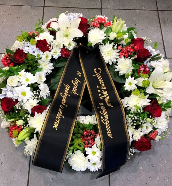 Funeral wreath: mix of red and white blooms