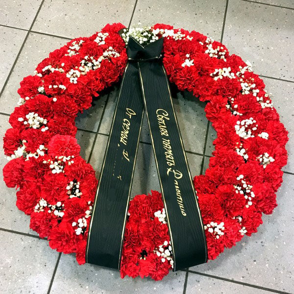 Funeral wreath with red dianthus