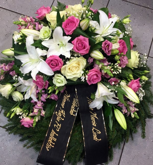 Large funeral wreath: pink and white roses, lisianthus, lilys