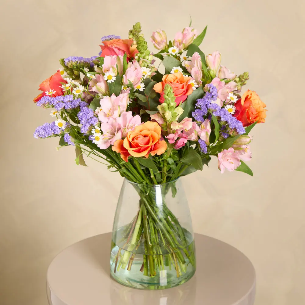 An uplifting bouquet of orange and pink flowers