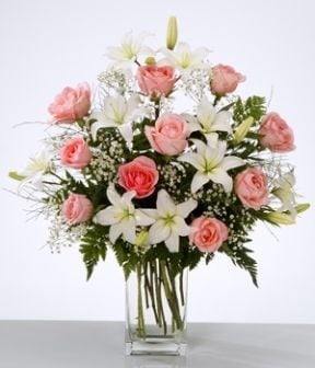 Floral arrangement in vase with white lilium and pink roses
