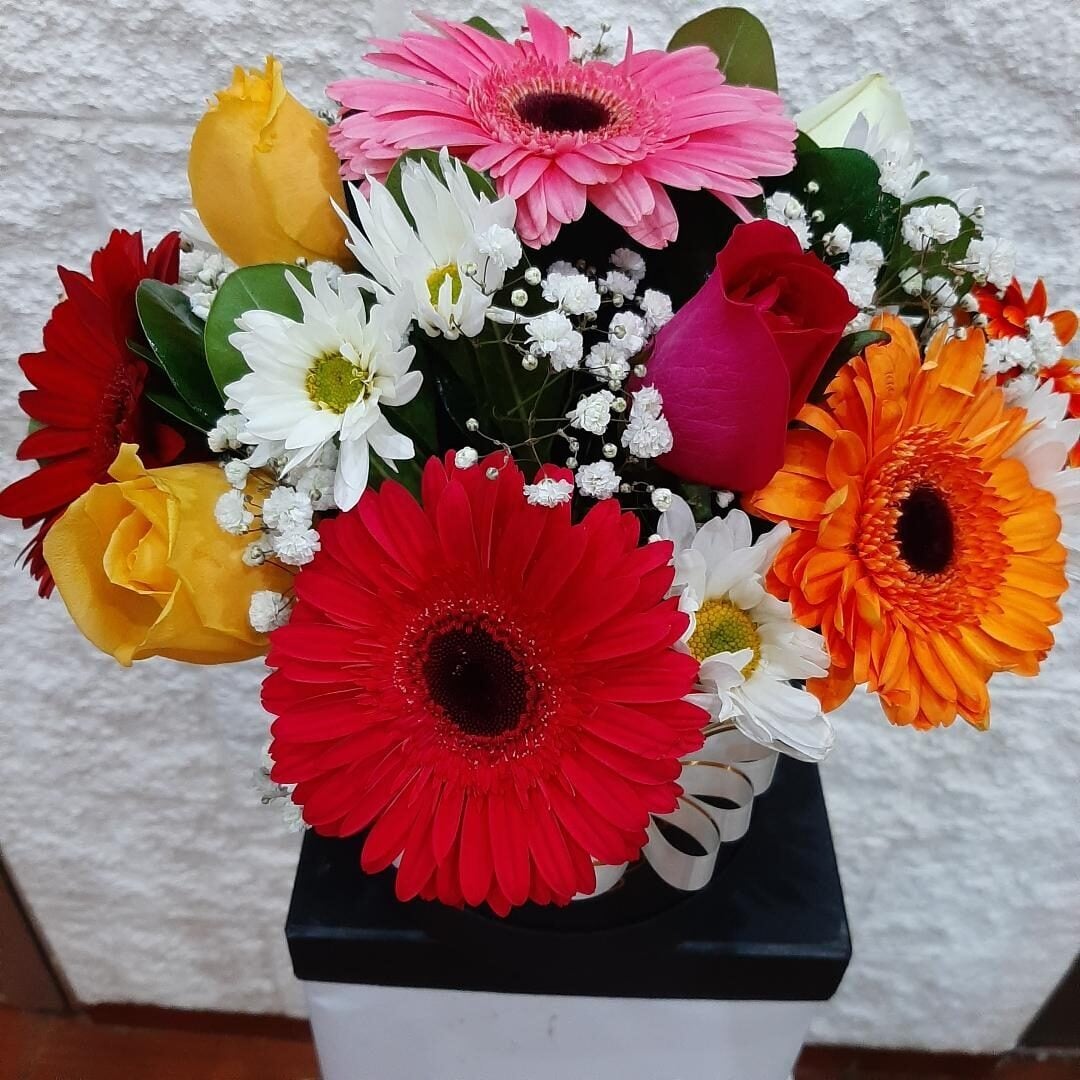 Box with gerberas and roses