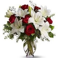 Vase with white lilium and red roses