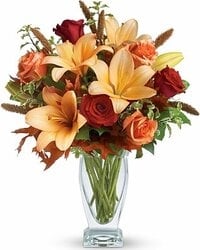 Vase with red lilium, roses, marg. and ocher tones alstromerias