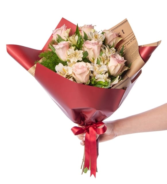 White and pink alstroemeria in a burgundy newspaper bouquet