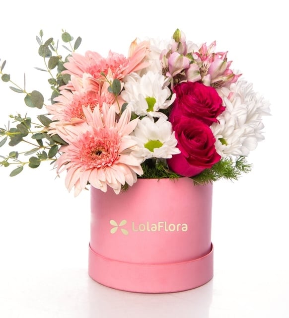 Pink alstroemerias, pink gerberas and white daisies in a pink box
