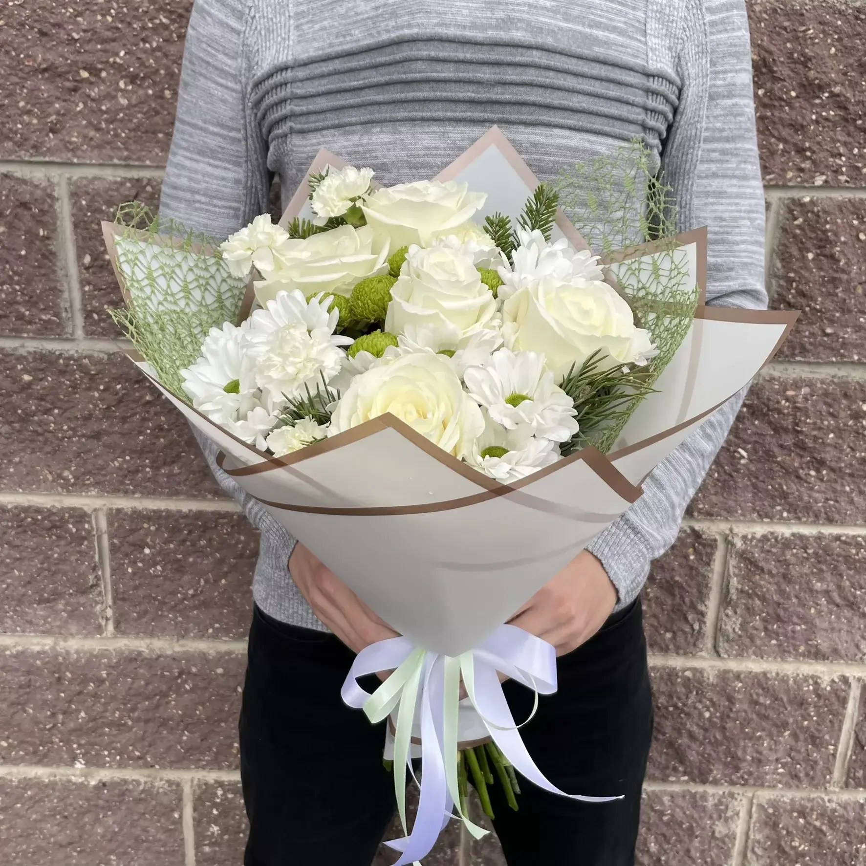 Delicate bouquet of roses and chrysanthemums in white tones