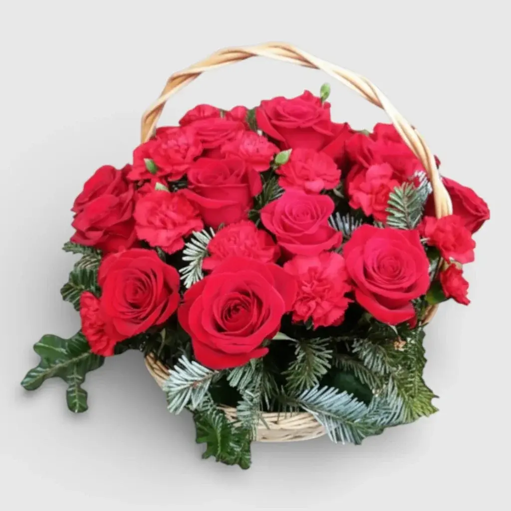 arrangement of roses and carnations in a basket
