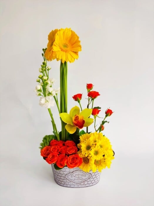 Beautiful orchid with roses, mini roses, gerberas and daisies