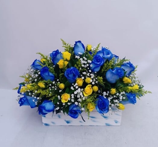 Floral arrangement with blue roses and mini roses