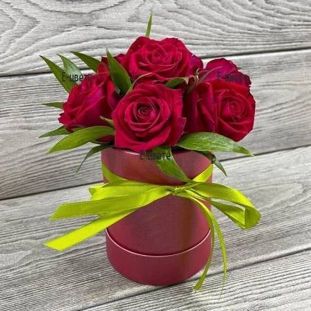 7 red roses in a round box