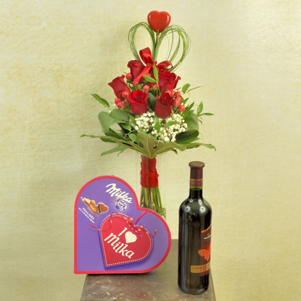 Red roses with candy and a bottle of wine